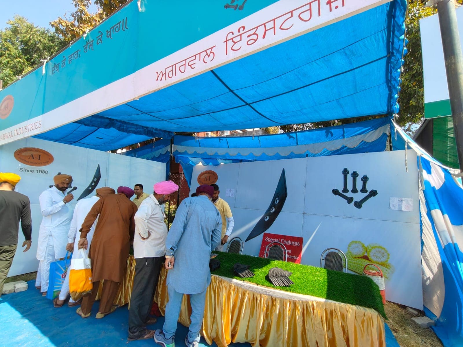 Farmers examining shovels and bolts at an Aggarwal Industries stall